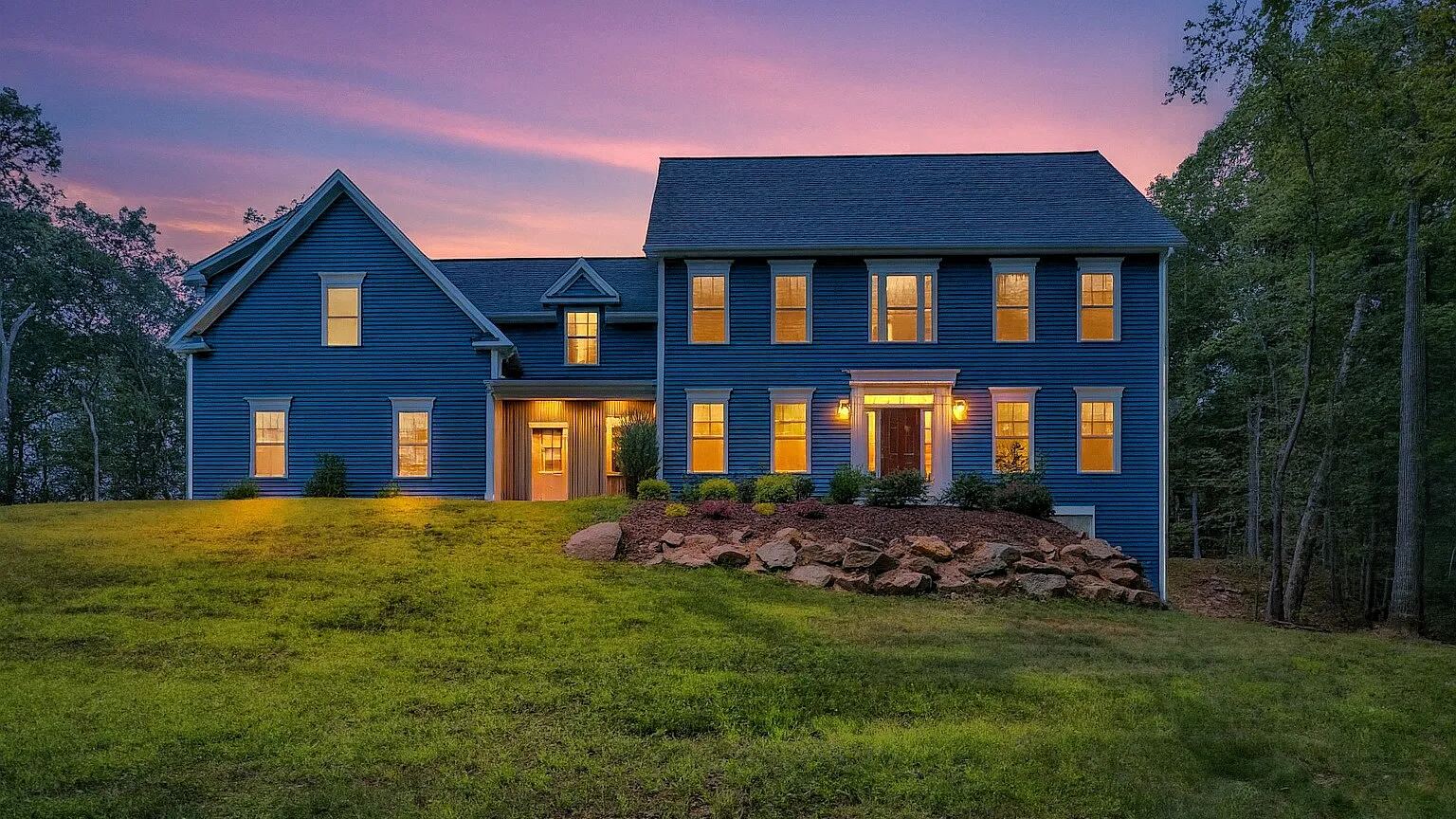 Blue colonial at dusk in Glastonbury CT